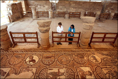 Mrs. Laura Bush tours the Petra Church with Dr. Barbara Porter, Director of the American Center for Oriental Research, during a walk through the ancient city that included homes, a temple, an amphitheater and royal tombs. The church was discovered in 1973 by an American archeologist. It's estimated that the church was built in the fifth century and included three apses. The mosaic tile covered both church's side aisles.