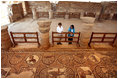 Mrs. Laura Bush tours the Petra Church with Dr. Barbara Porter, Director of the American Center for Oriental Research, during a walk through the ancient city that included homes, a temple, an amphitheater and royal tombs. The church was discovered in 1973 by an American archeologist. It's estimated that the church was built in the fifth century and included three apses. The mosaic tile covered both church's side aisles.