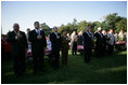 President George W. Bush and Laura Bush stand for the singing of the National Anthem during a visit with military support organizations Tuesday, Sept. 18, 2007, on the South Lawn.