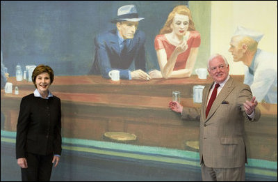 Mrs. Laura Bush stands with Rusty Powell III, Director of the National Gallery of Art, before entering an exhibit of paintings by American artist Edward Hopper Friday, Sept. 21, 2007, in Washington, D.C. The exhibit opened Sept. 16 and runs through Jan. 21, 2008. Pictured in the banner behind Mrs. Bush is Mr. Hopper's 1942 painting Nighthawks.