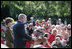 Standing with Mrs. Laura Bush, President George W. Bush addresses military support organizations Tuesday, Sept. 18, 2007, on the South Lawn. "Laura and I welcome the families who have got a loved one overseas, whether it be in Iraq or Afghanistan, fighting these extremists and terrorists," said President Bush. "The best way to honor your loved one is to make sure that he or she has the full support of the United State s government as you accomplish the mission that we have set."