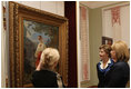 Mrs. Laura Bush and Mrs. Kateryna Yushchenko listen to Ms. Natalia Klimenko, General Director of the Taras Shevchenko National Museum, as she describes a painting by the great Ukrainian poet and artist during their tour Tuesday, April 1, 2008, in Kyiv.