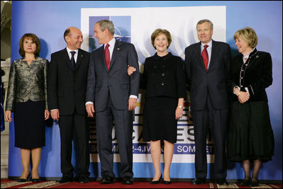 President George W. Bush and Mrs. Laura Bush share a light moment Wednesday, April 2, 2008, with Romania's President Taian Basescu and Mrs. Maria Basescu, left, and NATO Secretary General Jaap de Hoop Scheffer and Mrs. Jeannine de Hoop Scheffer during the NATO Summit official greeting at the Cotroceni Palace in Bucharest.