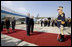 President George W. Bush stands with President Traian Basescu of Romania, during welcoming ceremonies Wednesday, April 2, 2008, at Mihail Kogalniceanu Airport in Constanta, Romania. With them on the red carpet are Mrs. Laura Bush and Mrs. Maria Basescu.