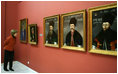 Mrs. Laura Bush peers in for a closer view of artwork during a visit Thursday, April 3, 2008, to the National Art Museum in Bucharest.