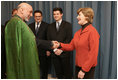 Mrs. Laura Bush greets Afghanistan President Hamid Karzai at the Headquarters of the Romanian Intelligence Service Thursday, April 3, 2008, where they participated in the Young Atlanticist Summit Video Conference with Kabul University.