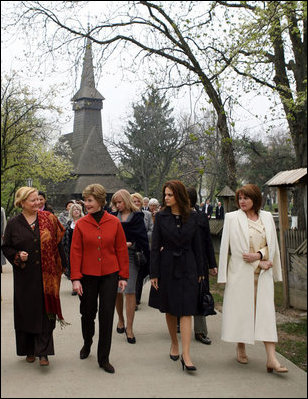 Mrs. Laura Bush walks with the spouses of NATO leaders Thursday, April 3, 2008, at the open-aired Dimitrie Gusti Village Museum in Bucharest. With her are Maria Basescu, right, spouse of Romania's President Traian Basescu, and Alexandra Coman, fiance of Romania's Foreign Minister Adrian Cioroianu. White House photo by Shealah Craighead