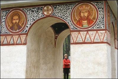 White House photo by Shealah Craighead Mrs. Laura Bush peers through an archway at the Dimitrie Gusti Village in Bucharest Thursday, April 3, 2008, as she joined fellow spouses of NATO leaders for a tour of the open-air museum.