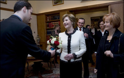 Mrs. Laura Bush accepts a bouquet of flowers as she arrives for tea Friday, April 4, 2008, with Mrs. Milka Mesic, right, spouse of Croatian President Stjepan Mesic, at the Office of the President in Zagreb.