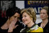 Mrs. Laura Bush watches the Lado National Fold Dance Ensemble performance, Saturday, April 5, 2008 in Zagreb, as an interpreter translates the performance lyrics for her.