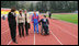 Mrs. Laura Bush walks on the track of Central Sochi Stadium Sunday, April 6, 2008, with Mr. Mikhail Terentyev, Secretary General of the Russian Paralympic Committee, Ms. Lisa Carty, spouse of the U.S. Ambassador to Russia William Burns, and Mrs. Irina Gromova, Coach of the Russian Paralympic team.