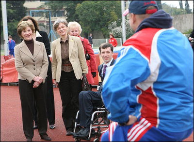 Mrs. Laura Bush visits with members of the Russian Paralympic Team Sunday, April 6, 2008, during a visit to Central Sochi Stadium in Sochi, Russia. Standing with her is her interpreter, Marina Gross.