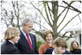 President George W. Bush and Mrs. Laura Bush watch kids shovel dirt to help plant a Scarlet Oak tree Wednesday, April 9, 2008, at the commemorative tree planting on the North Lawn of the White House. The Scarlet Oak replaces a tree planted by President Benjamin Harrison that fell on October, 25, 2007.