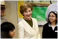 Mrs. Laura Bush joins students from the Williams Preparatory School in Dallas, Thursday, April 10, 2008, during a seed planting demonstration at the First Bloom program to help encourage youth to get involved with conserving America's National Parks. The First Bloom program is being introduced in five cities across the nation to give children a sense of pride in our natural resources and to be good stewarts of America's diverse environment.