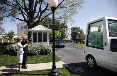 President George W. Bush and Laura Bush wave goodbye to Pope Benedict XVI as he prepares to leave the White House Wednesday, April 16, 2008 in the Pope mobile, following his official welcome to the White House.