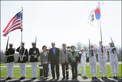 President George W. Bush and Laura Bush pose with South Korean President Lee Myung-bak and his wife, Kim Yoon-ok, for a photo Friday, April 18, 2008, on their arrival to the Presidential retreat at Camp David, Md.