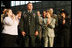 Mrs. Laura Bush joins the applause for Sgt. Gregory Williams after he was recognized by President George W. Bush Monday, Aug. 4, 2008, during remarks to military personnel at Eielson Air Force Base, Alaska.