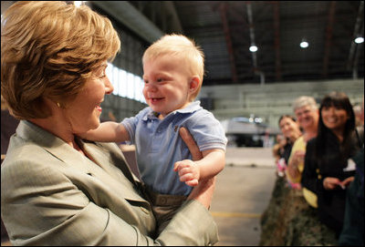 Mrs. Laura Bush receives a smile from a young boy as she greets the audience Monday, Aug. 4, 2008, after remarks by the President at Eielson Air Force Base, Alaska, their first stop en route to Asia.