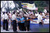 Crowds cheer and wave flags as the motorcade of President George W. Bush and Mrs. Laura Bush passes Tuesday, Aug. 5, 2008, following President Bush's arrival to Seoul, South Korea.