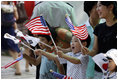 Children wave American and South Korean flags during the visit of President George W. Bush and Mrs. Laura Bush Wednesday, August 6, 2008, to Seoul. 