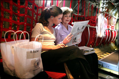 Mrs. Laura Bush and her daughter Ms. Barbara Bush go over information on the plane as they fly to Thailand on Aug. 7, 2008. The visit highlighted the problems facing the Burmese refugees living inside the Thailand border in nine refugee camps. It has been 20 years since the Aug. 8, 1988 crackdown in Burma. Since 2005 alone, a little over 30,000 Burmese have moved to the United States to find a home and escape the dire conditions.