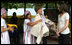 Mrs. Laura Bush and daughter Ms. Barbara Bush examine local wares after a dance ceremony and viewing traditional Karen weaving at the Mae La Refugee Camp at Mae Sot, Thailand, on Aug. 7, 2008. Mrs. Bush's visit to one of the largest refugee camps on the border was at the top of a mountain on the border with Burma. In her comments, Mrs. Bush noted the generosity of the Thai government and the people of Thailand in allowing the nine camps to exist there.