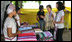 Mrs. Laura Bush and daughter Ms. Barbara Bush look over the weaving done by refugee women at the Mae La Refugee Camp at Mae Sot, Thailand, on Aug. 7, 2008. This traditional Karen craft helps the refugees make money and can be bought via the Internet through consortiums that work with the women in the camp which houses at least 39,000 Burmese.