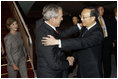 President George W. Bush and Mrs. Laura Bush are greeted by China's Foreign Minister Yang Jiechi, upon their arrival Thursday, Aug. 7, 2008, at Beijing Capitol International Airport in Beijing, where they will attend the opening ceremonies for the 2008 Summer Olympic Games on Friday.