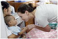 Ms. Barbara Bush, daughter of President George W. Bush and Mrs. Laura Bush, spends a playful moment with a small child during her visit to the Mae Tao Clinic at the Mae La Refugee Camp in Mae Sot, Thailand Thursday, Aug. 7, 2008. 