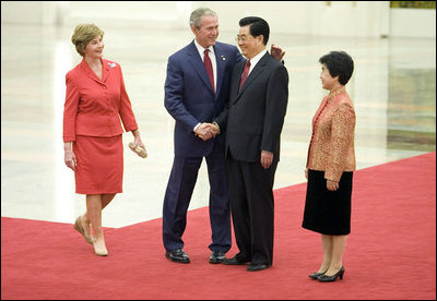 President George W. Bush and Mrs. Laura Bush are greeted by Chinese President Hu Jintao and Madam Liu Yongqing at the Great Hall of the People in Beijing Friday, Aug. 8, 2008, for the social lunch in honor of the 2008 Summer Olympic Games.