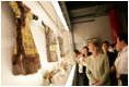 Mrs. Laura Bush closely examines a display at the Exhibition of Imperial Garments and Jewelry Saturday, Aug. 9, 2008, during her tour of the Forbidden City in Beijing.