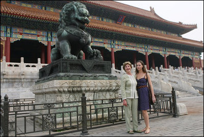 Mrs. Laura Bush and daughter Barbara Bush pause next to a Fu Dog during a visit Friday, Aug. 9, 2008, to the Forbidden City in Beijing.