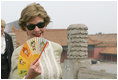 Mrs. Laura Bush finds relief from the Beijing heat in an ornamental fan during a visit Friday, Aug. 9, 2008, to the Forbidden City.