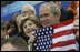 President George W. Bush and Mrs. Laura Bush cheer on the U.S. Olympic swimmers during the Sunday morning competition at the National Aquatics Center in Beijing.