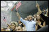 President George W. Bush, Mrs. Laura Bush and daughter Barbara Bush join the fans at the National Aquatics Center as they cheer on U.S. swimmer Michael Phelps as he swam his world-record setting 400-Meter Individual Medley event Sunday, Aug. 10, 2008, in Beijing.