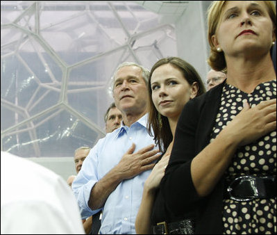 President George W. Bush, daughter Barbara Bush and Mrs. Doro Koch, the President's sister, stand for the playing of the U.S. national anthem Sunday, Aug. 10, 2008, during the medal ceremony honoring gold medalist Michael Phelps. The U.S. Olympian won his first event, the 400-meter Individual Medley, in a record time of 4:3.84.