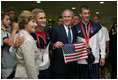 President George W. Bush and Mrs. Laura Bush pose for photos with U.S. Olympic swimmers Larsen Jensen, left, and Michael Phelps Sunday, Aug. 10, 2008, at the National Aquatics Center in Beijing.