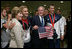 President George W. Bush and Mrs. Laura Bush pose for photos with U.S. Olympic swimmers Larsen Jensen, left, and Michael Phelps Sunday, Aug. 10, 2008, at the National Aquatics Center in Beijing.