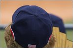 Mrs. Laura Bush wearing a U.S. Olympic baseball team hat watches the U.S. Olympic men's baseball team play a practice game against the Chinese Olympic men's baseball team Monday, Aug. 11, 2008, at the 2008 Summer Olympic Games in Beijing.