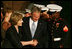 Laura Bush greets participants of the Evening Parade at the Marine Barracks in Washington, D.C., as President George W. Bush looks down at the official barracks mascot, Chesty Friday, August 29, 2008, in Washington D.C. 