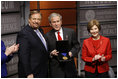 President George W. Bush, joined by Mrs. Laura Bush, is presented with the International Medal of PEACE by Pastor Rick Warren, Monday, Dec. 1, 2008, following their partipation at the Saddleback Civil Forum on Global Health in Washington, D.C.