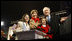 President George W. Bush and Mrs. Laura Bush are joined by tree lighters Kayleigh Kepler, 11, left, and Lindsey Van Horn, 9, during the 2008 Lighting of the National Christmas Tree Thursday, Dec. 4, 2008, on the Ellipse in Washington, D.C.