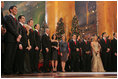 Mrs. Laura Bush joins Dr. Phil McGraw and his wife Robin, center-left, along with stage performers Sunday, Dec. 14, 2008, during the annual Christmas in Washington performance at the National Building Museum in Washington D.C.