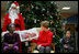 Mrs. Laura Bush reads "My Penguin Osbert" Monday, Dec. 15, 2008 to a gathering of patients and their families at Children's National Medical Center in Washington, D.C. Sitting with her are patient escort volunteers Dania Jecty, left, age 11, and Elmer Reyes, age 13.