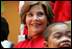 Mrs. Laura Bush watches Barney Cam VII: A Red, White & Blue Christmas as it debuts for children at Children's National Medical Center in Washington, D.C. on Dec. 15, 2008. With Mrs. Bush are her two patient escort volunteers, Dania Jecty, left, age 11, and Elmer Reyes, age 13. Visiting the hospital is an annual tradition for Mrs. Bush, and one she says she will miss.