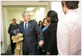 With Mrs. Laura Bush by his side, President George W. Bush speaks to reporters Monday, Dec. 22, 2008, during a visit to the Pathways to Housing DC, a distribution site for the One Warm Coat Holiday Service Project, in Washington, D.C. Modeled after the first Pathways to Housing program in New York City founded in 1992, Pathways to Housing DC works with individuals who have been turned away from other programs.