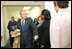 With Mrs. Laura Bush by his side, President George W. Bush speaks to reporters Monday, Dec. 22, 2008, during a visit to the Pathways to Housing DC, a distribution site for the One Warm Coat Holiday Service Project, in Washington, D.C. Modeled after the first Pathways to Housing program in New York City founded in 1992, Pathways to Housing DC works with individuals who have been turned away from other programs.