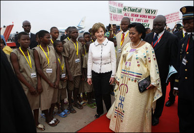 Mrs. Laura Bush and Madame Chantal de Souza Yayi, First Lady of Benin, walk the red carpet upon the arrival Saturday, Feb. 16, 2008, of Mrs. Bush and President George W. Bush to Benin.