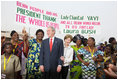 President George W. Bush and Mrs. Laura Bush pose with women at Cadjehoun International Airport in Cotonou, Benin Saturday, Feb. 16, 2008, after they greeted the President and First Lady upon arrival.