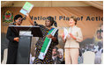 Mrs. Laura Bush applauds as Mrs. Salma Kikwete, First Lady of Tanzania, holds up the National Costed Plan of Action for Most Vulnerable Children, 2007-2010, supported both financially and technically by PEPFAR and UNICEF, during the visit by Mrs. Bush to the WAMA Foundation in Dar es Salaam.